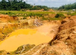 Ghana Galamsey Satire: Eating Death with a Smile Ghana galamsey satire — polluted mining pit with toxic yellow water showing environmental destruction